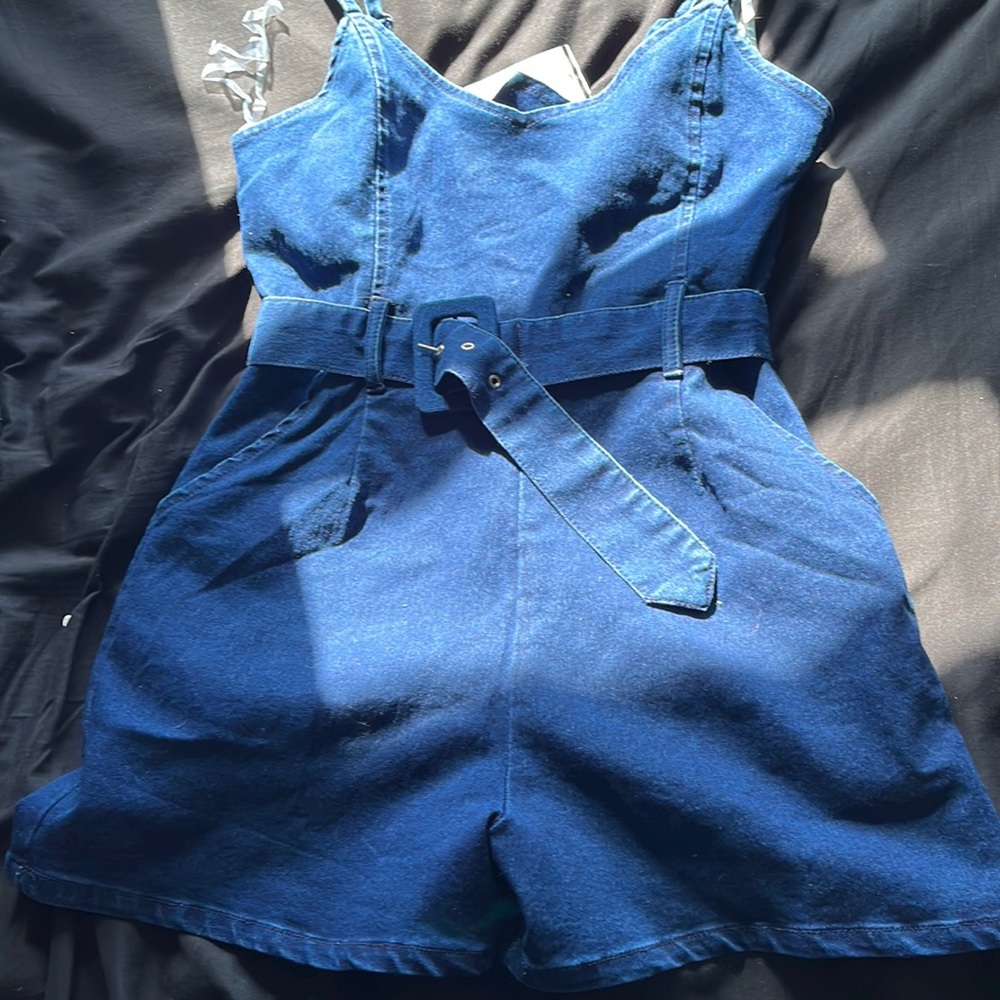 Brand new, never wore romper. Adjustable belt and straps. Has pockets